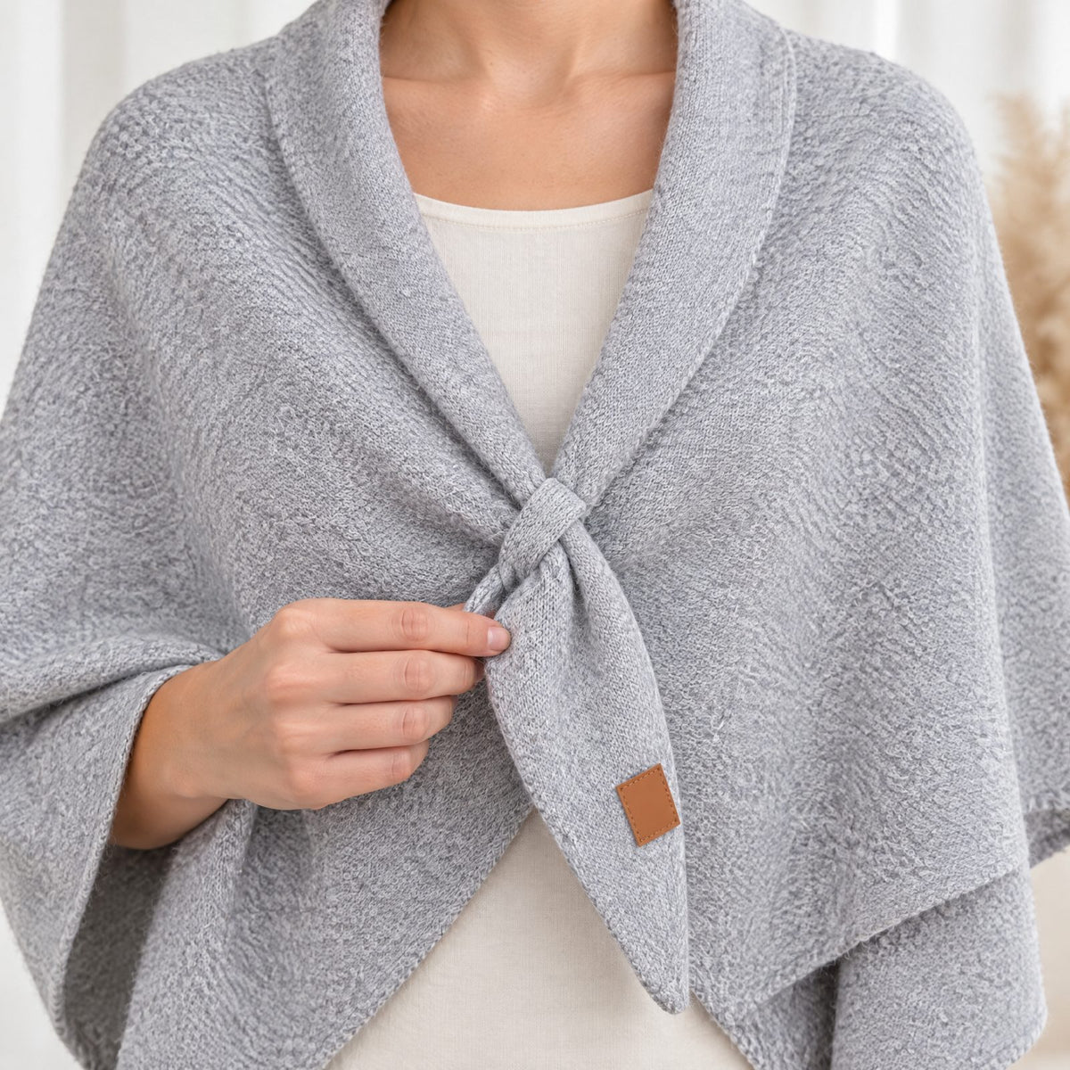 Close-up of the small front loop holding The Loop Shawl in place, light grey