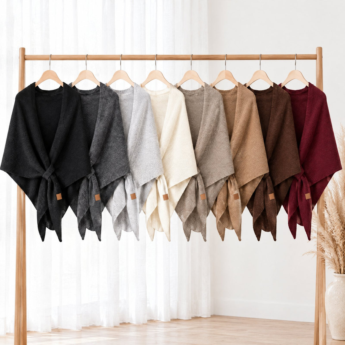 The Loop Shawl in all eight colours hanging on a clothes rail