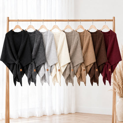 The Loop Shawl in all eight colours hanging on a clothes rail
