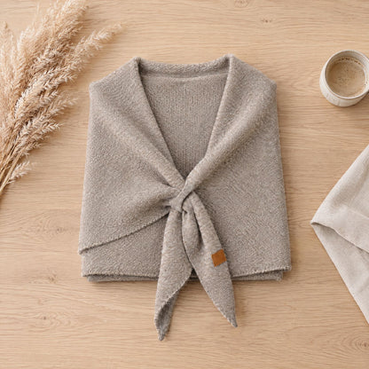 The Loop Shawl in khaki laid flat on a wooden table