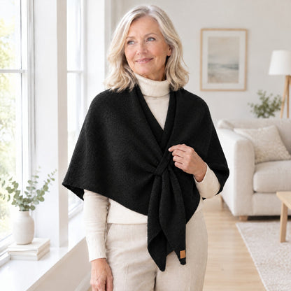 Woman wearing The Loop Shawl in black over a cream turtleneck