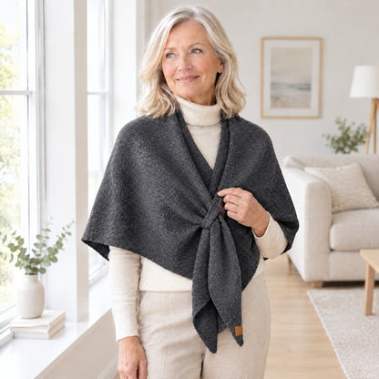 Woman wearing The Loop Shawl in dark grey over a cream turtleneck
