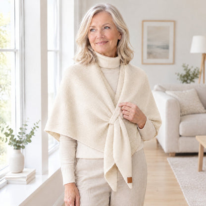 Woman wearing The Loop Shawl in ivory over a cream turtleneck