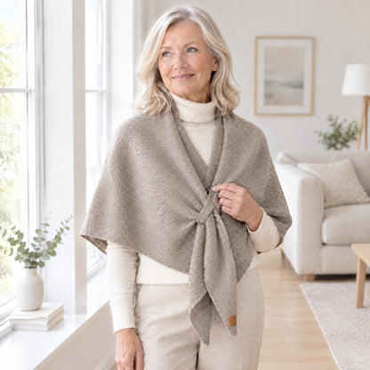 Woman wearing The Loop Shawl in khaki over a cream turtleneck