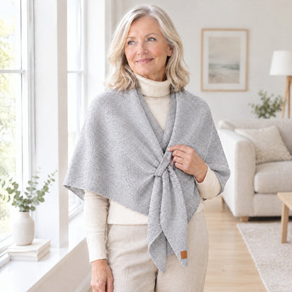 Woman wearing The Loop Shawl in light grey over a cream turtleneck